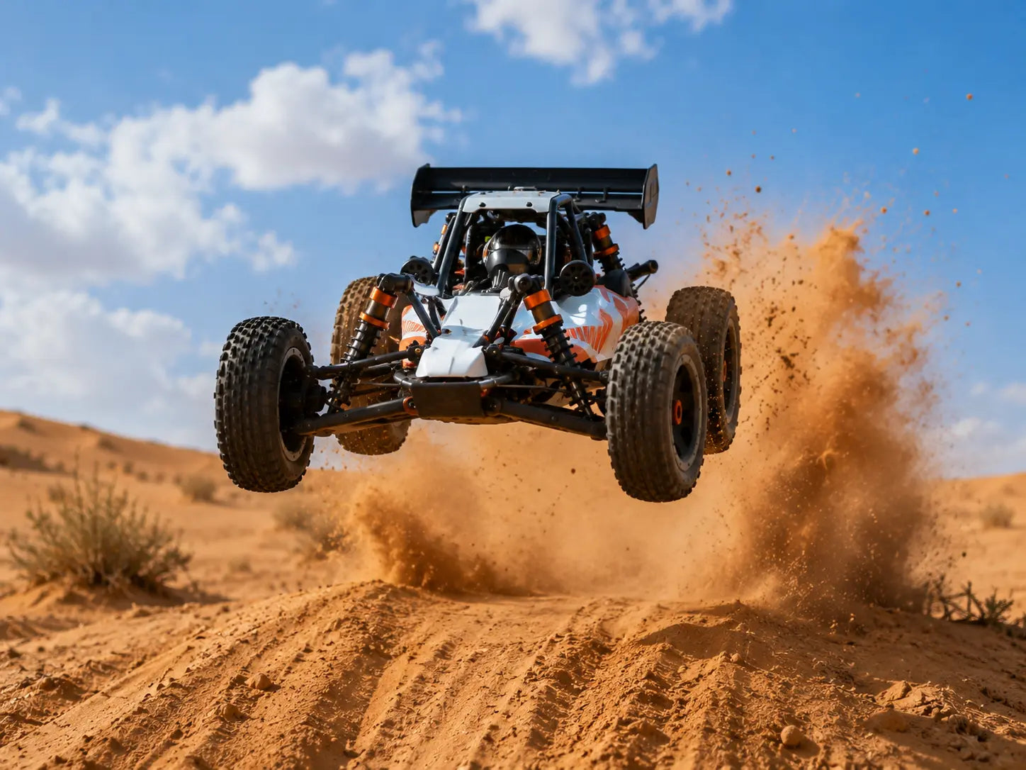 RC buggy Baja 1/5 jumping over desert dunes.
